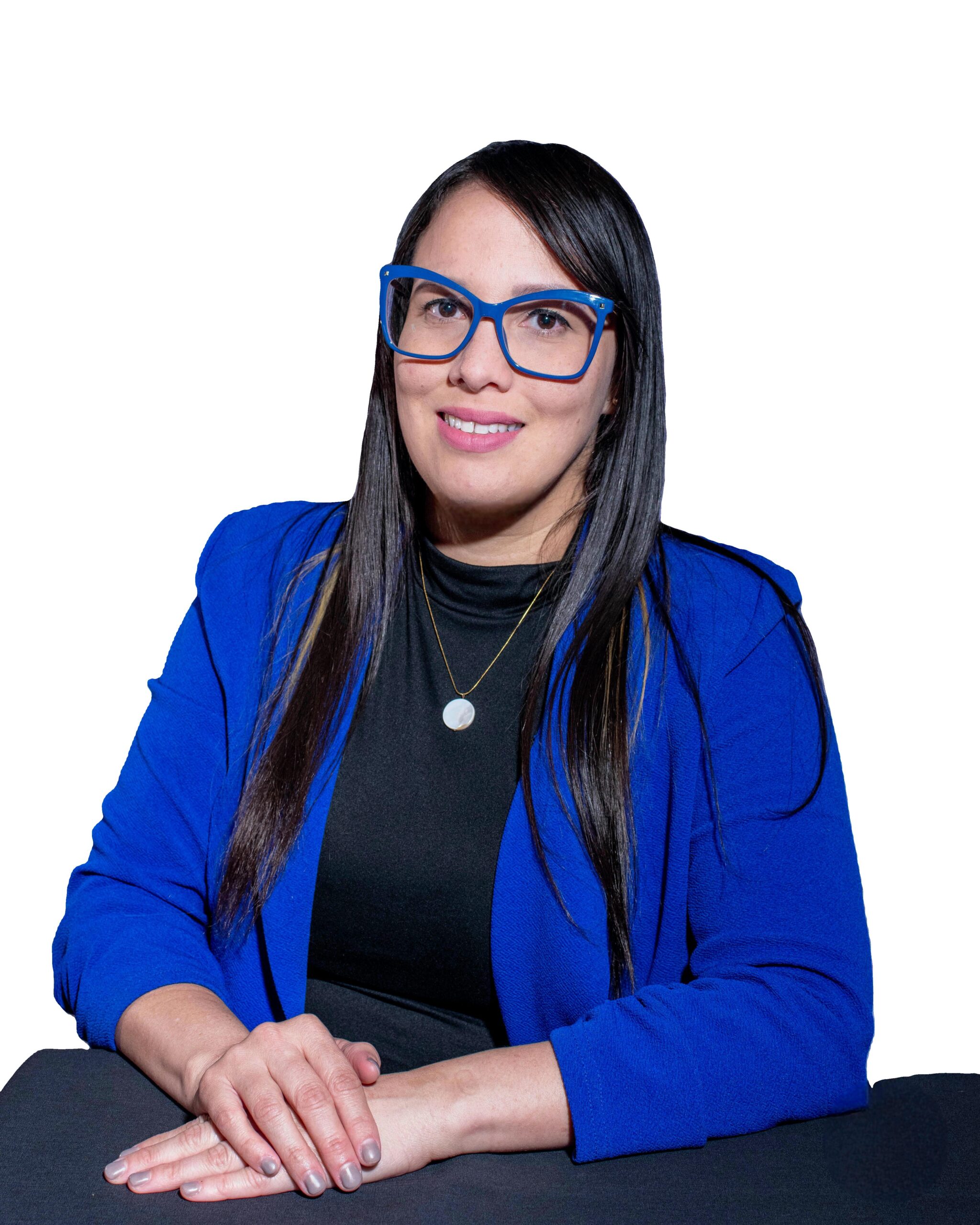 A portrait of Frances Santiago Hernandez, a smiling woman with long dark hair. She is wearing bright blue rectangular glasses, a black high-necked top, a gold pendant necklace, and a vivid blue blazer, set against a white background.